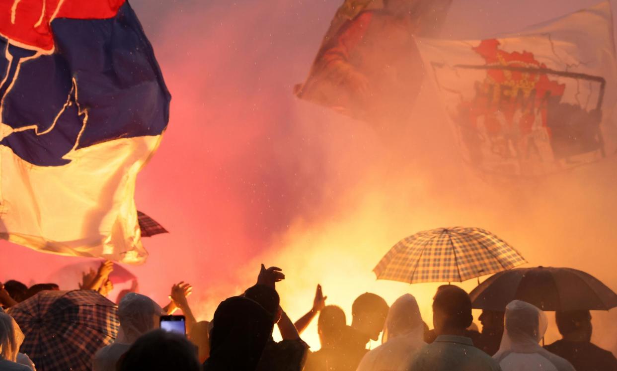 <span>Protesters in Belgrade set off flares during a rally against the Mirëdita Dobar Dan arts festival.</span><span>Photograph: Andrej Čukić/EPA</span>