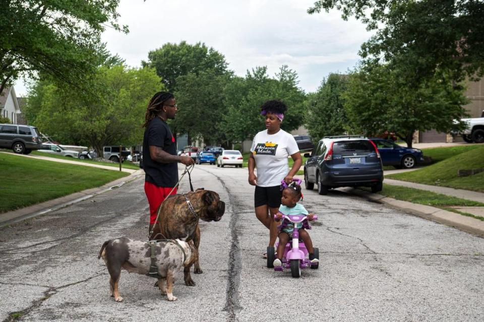 John Roddy, his wife Mika and their daughter Esrael take an evening walk with their dogs on a warm summer evening in Blue Springs. Zachary Linhares/The Kansas City Star