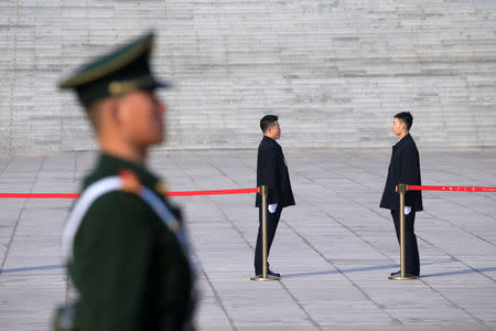 Security personnel keep watch outside the Great Hall of the People ahead of National People's Congress (NPC), China's annual session of parliament, in Beijing, China March 4, 2019. REUTERS/Aly Song