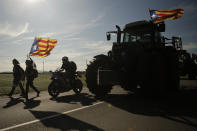 Demonstrators march along a highway near Girona, Spain, Wednesday, Oct. 16, 2019. Thousands of people have joined five large protest marches across Catalonia that are set to converge on Barcelona, as the restive region reels from two straight days of violent clashes between police and protesters. The marches set off from several Catalan towns and aimed to reach the Catalan capital by Friday. (AP Photo/Joan Mateu)