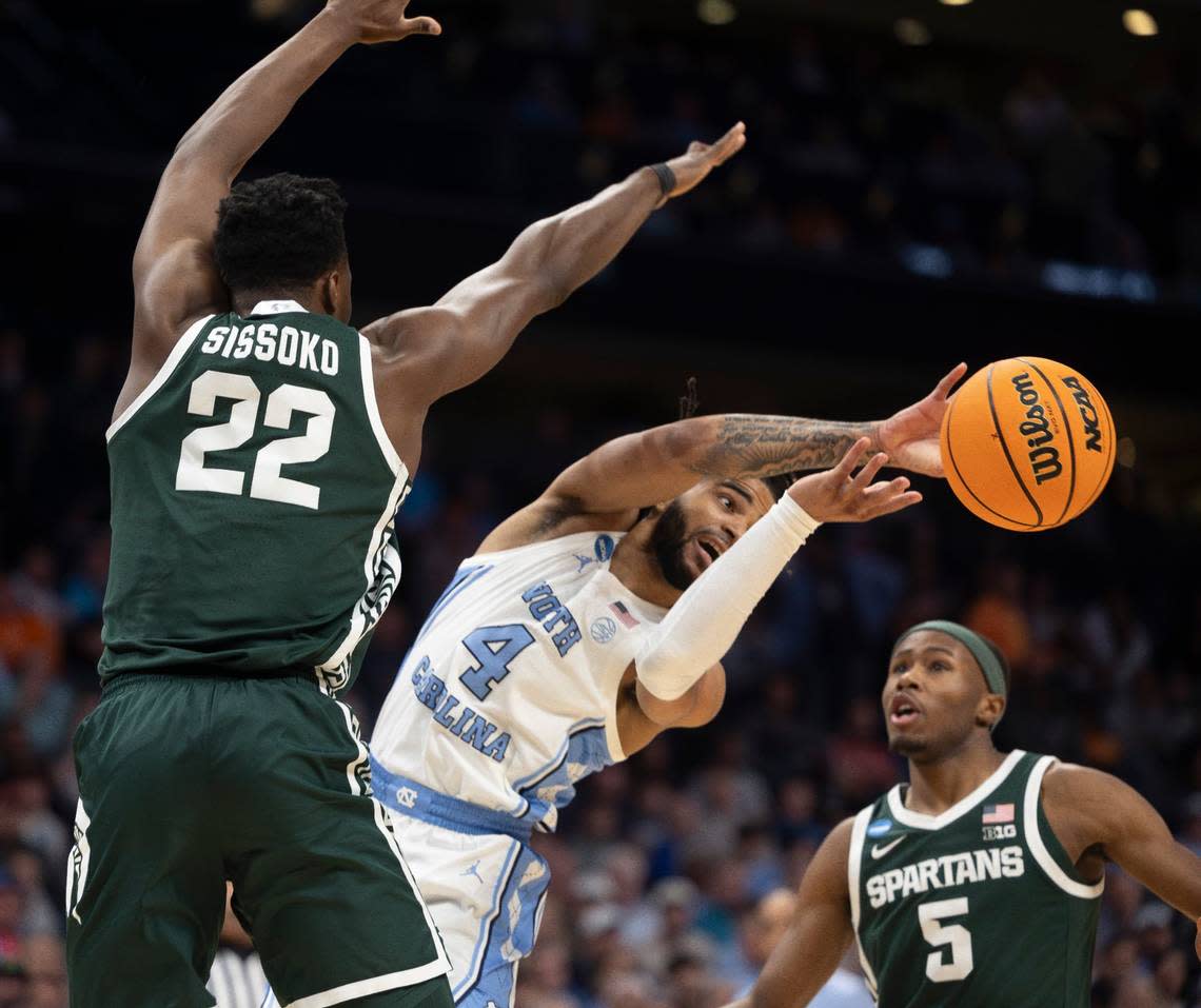 Michigan State’s Mady Sissoko (22) and Tre Holloman (5) trap North Carolina’s R.J. Davis (4) during the second half on Saturday, March 23, 2024, during the second round of the NCAA Tournament at Spectrum Center in Charlotte, N.C.