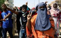 Civilians chant slogans as members of Sudanese pro-democracy protest on the anniversary of a major anti-military protest, as groups loyal to toppled leader Omar al-Bashir plan rival demonstrations in Khartoum