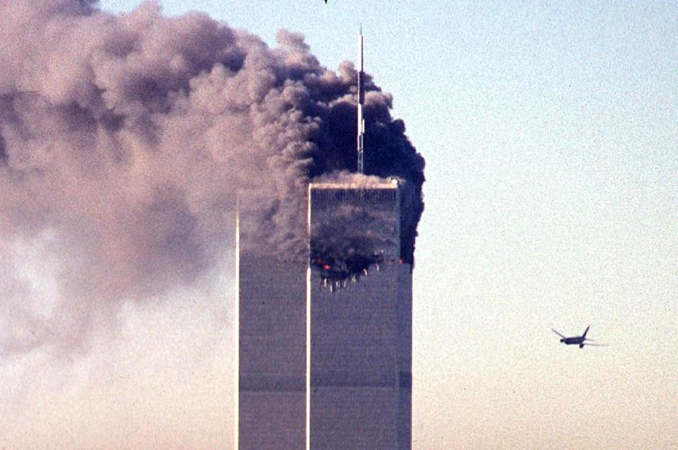 (FILES) In this file photo taken on September 11, 2001, a hijacked commercial aircraft approaches the twin towers of the World Trade Center shortly before crashing into the landmark skyscraper in New York. The remains of two more victims of 9/11 have been identified, thanks to advanced DNA technology, New York officials announced on September 8, 2021, just days before the 20th anniversary of the attacks. The office of the city's chief medical examiner said it had formally identified the 1,646th and 1,647th victim of the al-Qaeda attacks on New York's Twin Towers which killed 2,753 people. They are the first identifications of victims from the collapse of the World Trade Center since October 2019. / AFP / SETH MCALLISTER