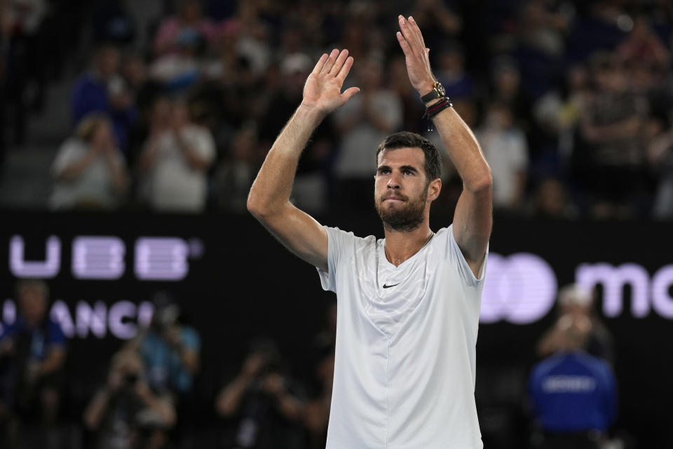 Karen Khachanov of Russia waves after Sebastian Korda of the U.S. withdrew their quarterfinal match with an injured wrist at the Australian Open tennis championship in Melbourne, Australia, Tuesday, Jan. 24, 2023. (AP Photo/Ng Han Guan)