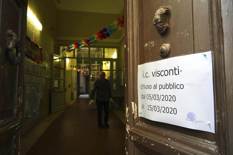 A note advising that the Ennio Quirino Visconti school will be closed through March 15 hangs from a door, in Rome, Thursday, March 5, 2020. Italy's virus outbreak has been concentrated in the northern region of Lombardy, but fears over how the virus is spreading inside and outside the country has prompted the government to close all schools and Universities nationwide for two weeks. (AP Photo/Andrew Medichini)