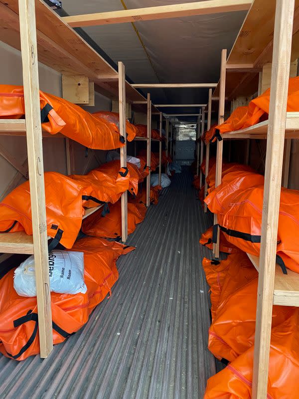 Bodies are seen inside a makeshift morgue outside Wyckoff Hospital