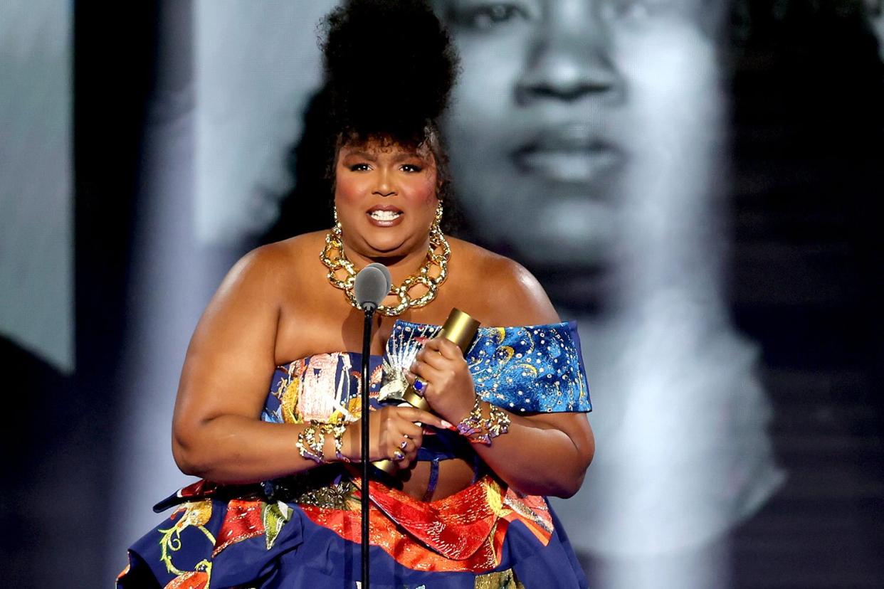 SANTA MONICA, CALIFORNIA - DECEMBER 06: 2022 PEOPLE'S CHOICE AWARDS -- Pictured: Honoree Lizzo accepts The People's Champion award on stage during the 2022 People's Choice Awards held at the Barker Hangar on December 6, 2022 in Santa Monica, California. --  (Photo by Rich Polk/E! Entertainment/NBC via Getty Images)