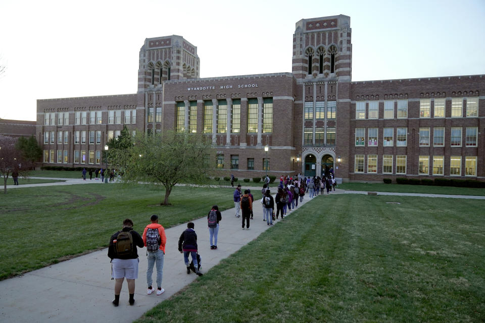 FILE - In this Wednesday, March 31, 2021, file photo, students wait to enter Wyandotte County High School in Kansas City, Kan., on the first day of in-person learning. The district was one of the last in the state to return to the classroom after going virtual due to the COVID-19 pandemic. (AP Photo/Charlie Riedel, File)