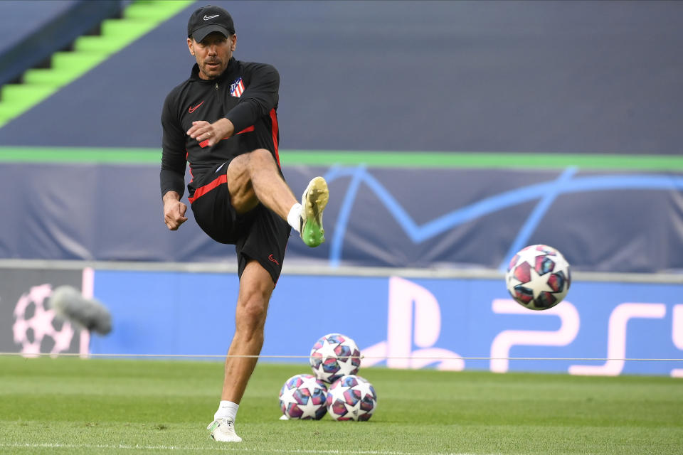 Atletico Madrid's head coach Diego Simone kicks a ball during a training session at the Jose Alvalade stadium in Lisbon, Wednesday Aug. 12, 2020. Atletico Madrid will play Leipzig in a Champions League quarterfinals soccer match on Thursday. (Lluis Gene/Pool via AP)