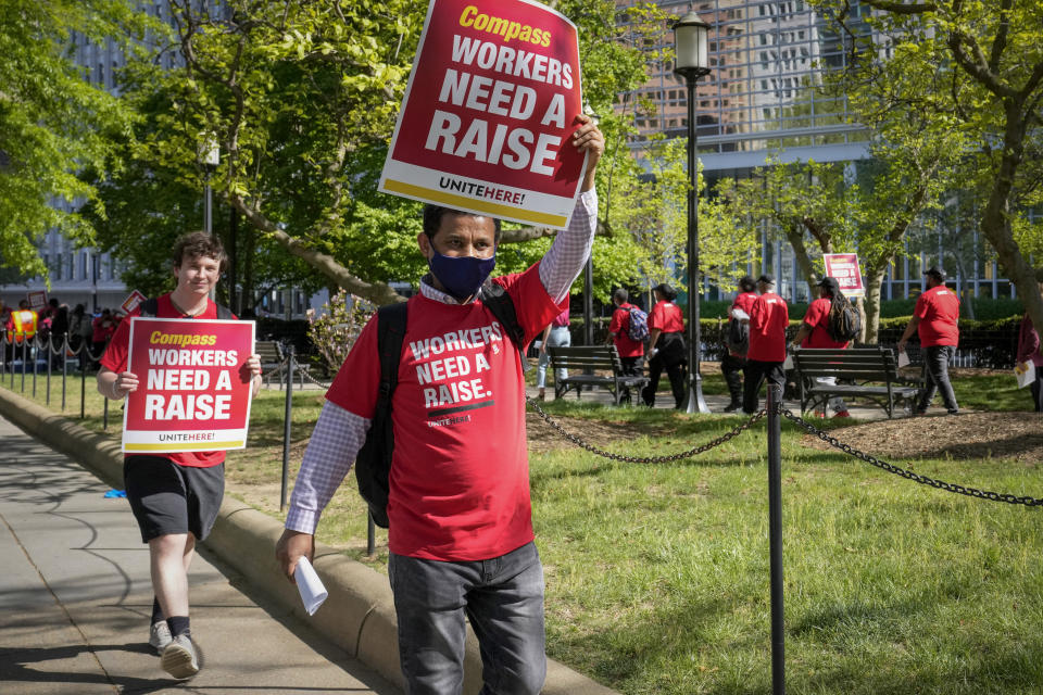 Workers who are contracted to feed World Bank employees through a firm called the Compass Group, protest for higher wages and affordable healthcare benefits, Wednesday, April 12, 2023, outside of the World Bank in Washington. (AP Photo/Mariam Zuhaib)