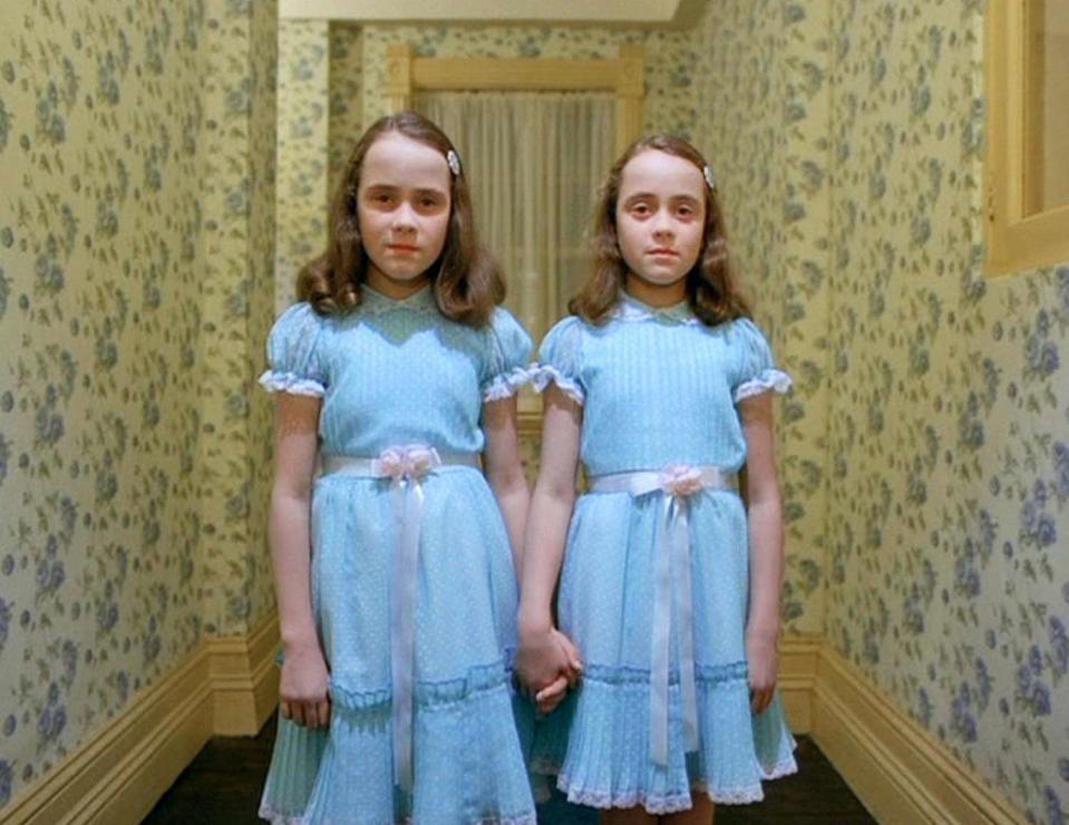 The twin girls in their blue dresses in a film still from The Shining.