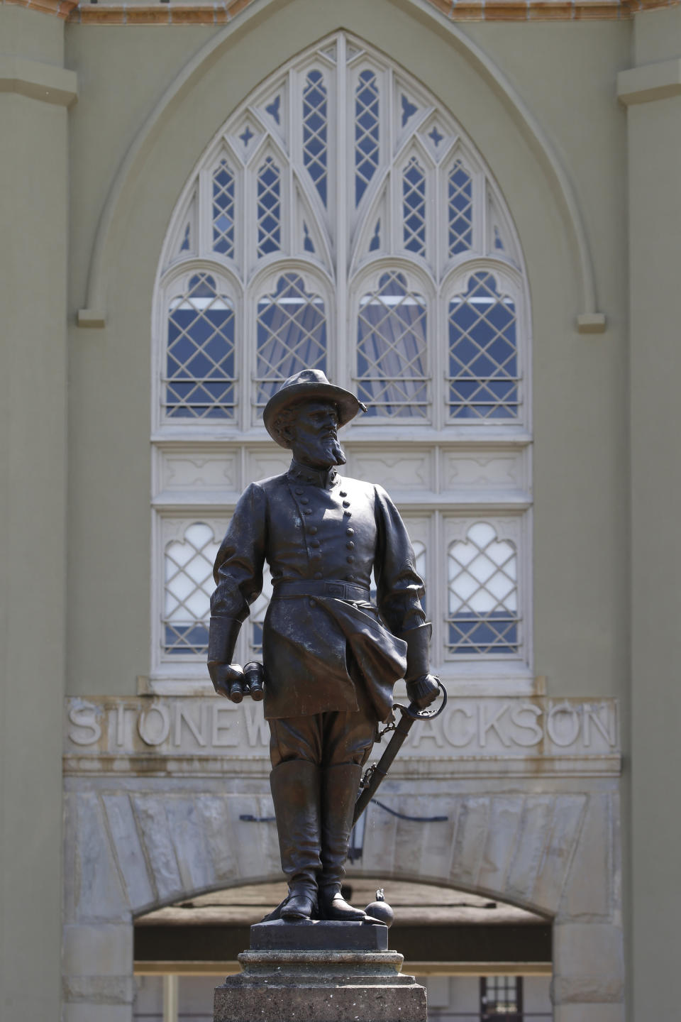 FILE - In this July 15, 2020 file photo the statue of Confederate General Stonewall Jackson stands at the entrance to the barracks at the Virginia Military Institute in Lexington, Va. Virginia Military Institute's Board of Visitors voted Thursday, Oct. 30 to remove the prominent statue. (AP Photo/Steve Helber)