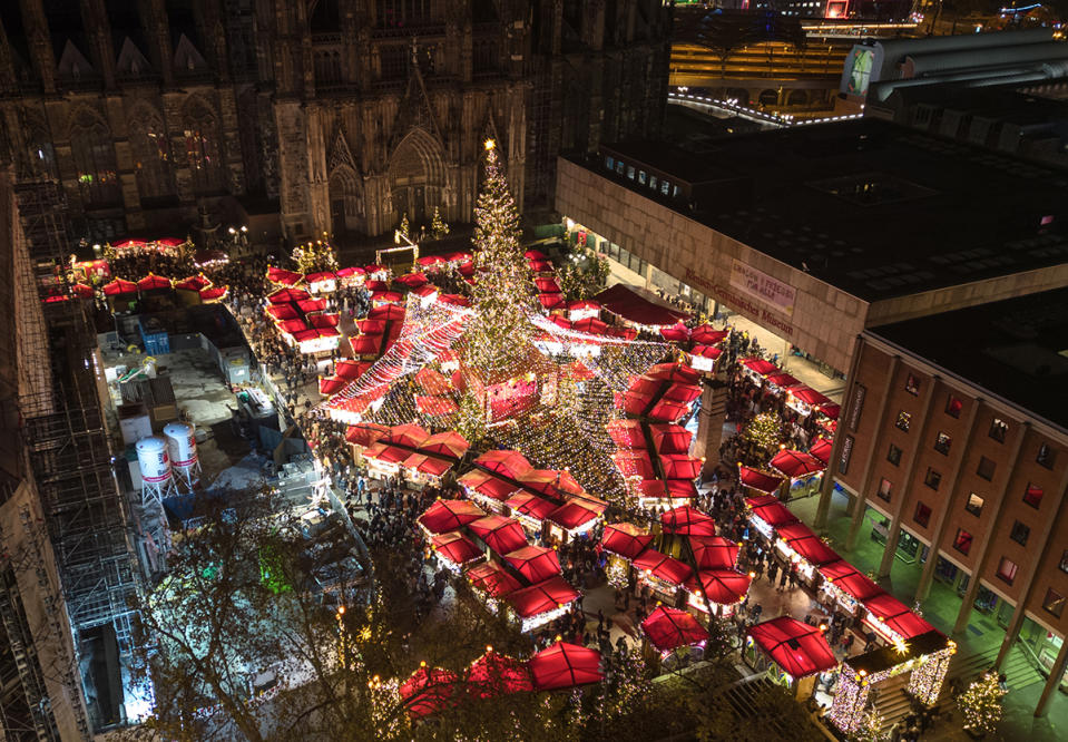 best christmas markets around the world, 02 December 2022, North Rhine-Westphalia, Cologne: View from above of the Christmas market at the cathedral in Cologne. In many places in North Rhine-Westphalia, the Christmas markets are as busy as they were before the Corona pandemic. Numerous tourists are traveling again this year for the special experience. (to dpa: "Longing and coziness: Christmas markets popular as before Corona") Photo: Sascha Thelen/dpa (Photo by Sascha Thelen/picture alliance via Getty Images)