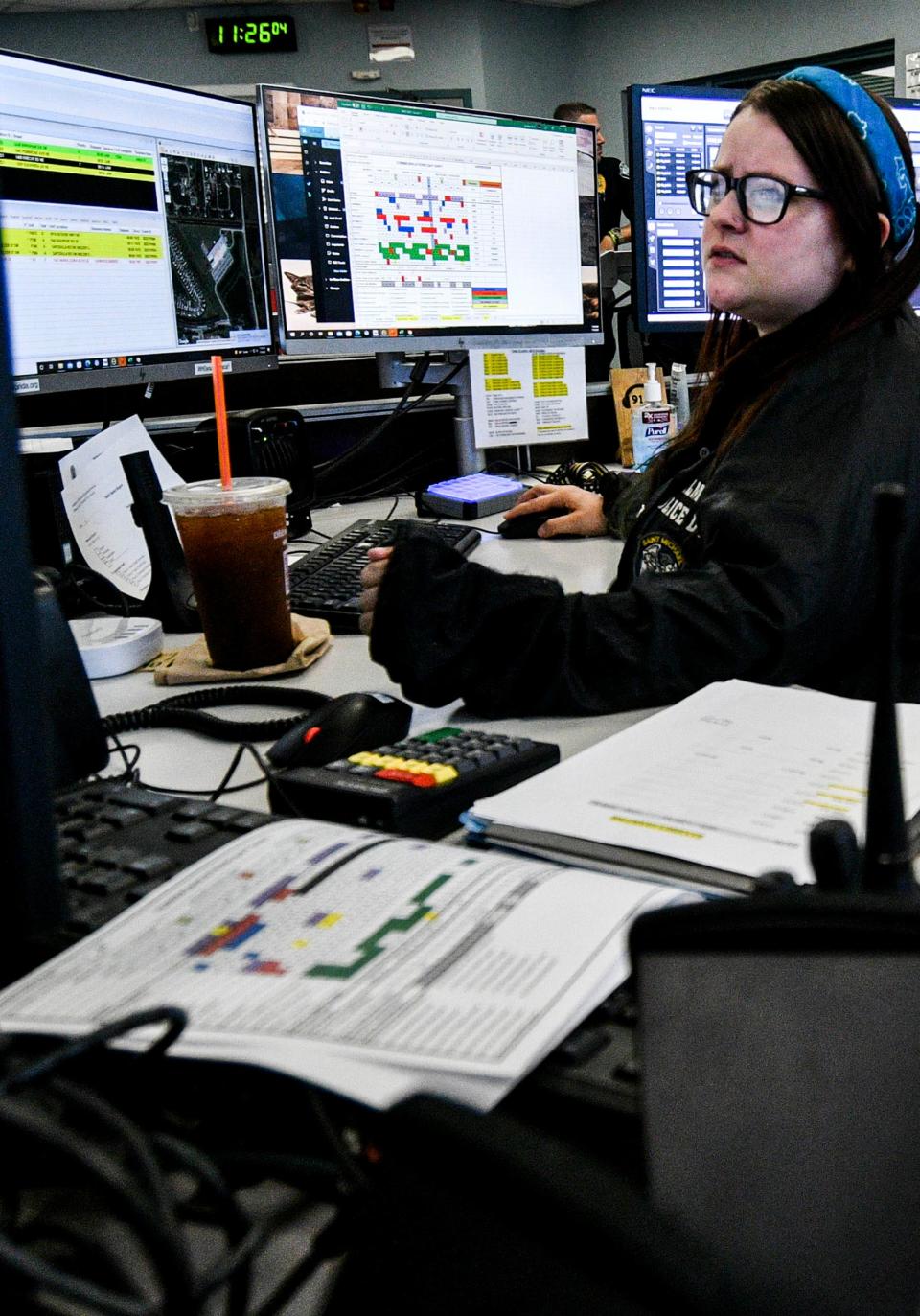 Palm Bay police dispatcher Lyndsey Veina answers a call inside the department's communications center.