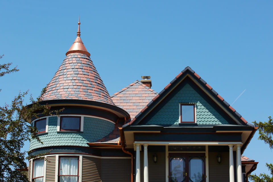 This 2012 photo provided by DaVinci Roofscapes shows a red and grey colored roof that replaced a storm damaged black one at Carol and Ray Knoff's home in Vinton, Iowa. The colors, produced by DaVinci Roofscapes, are typical of the original roofs on Victorian homes. (AP photo/DaVinci Roofscapes)