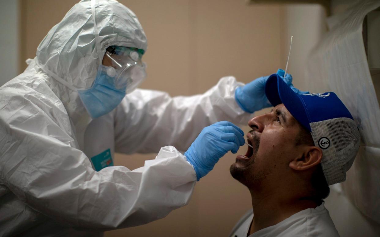 File image of a health worker taking a sample swab to test for coronavirus - AP