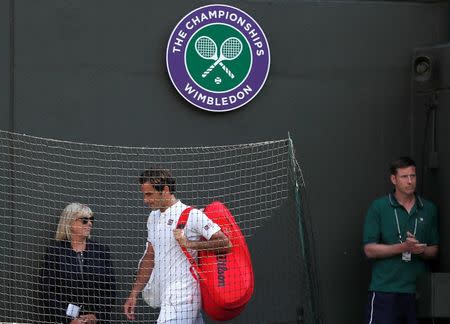 Tennis - Wimbledon - All England Lawn Tennis and Croquet Club, London, Britain - July 11, 2018. Switzerland's Roger Federer walks off court after loosing his quarter final match against South Africa's Kevin Anderson . REUTERS/Andrew Boyers