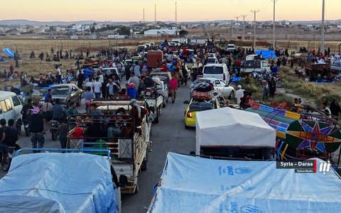 People in their vehicles who fled from Daraa in late June gathering near the Syria-Jordan border - Credit: Nabaa Media