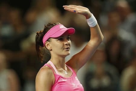 Poland's Agnieszka Radwanska waves after winning her fourth round match against Germany's Anna-Lena Friedsam at the Australian Open tennis tournament at Melbourne Park, Australia, January 24, 2016. REUTERS/Brandon Malone