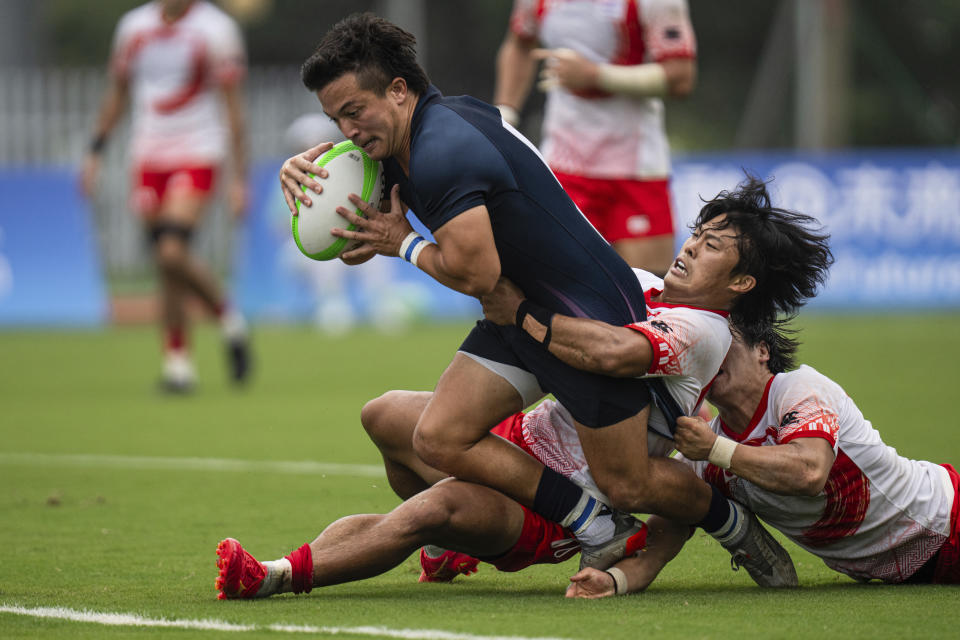 Hong Kong's James Murray Christie runs to score a try during the men's semifinal Rugby Sevens match between Hong Kong and Japan at the 19th Asian Games in Hangzhou, China, Tuesday, Sept. 26, 2023. (AP Photo/Louise Delmotte)