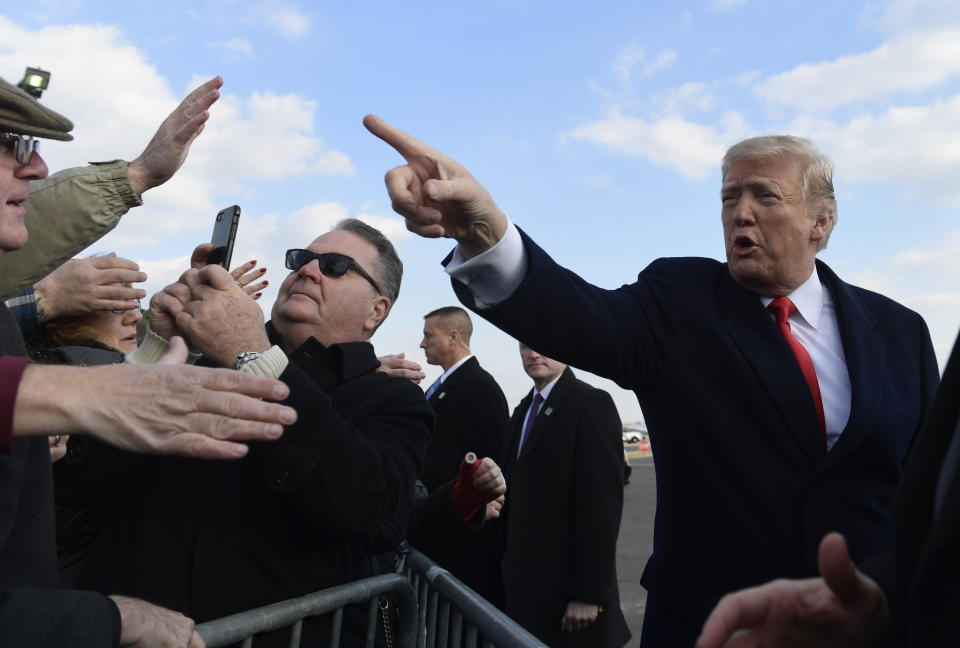 President Donald Trump greets people after arriving via Air Force One at Philadelphia International Airport in Philadelphia, Saturday, Dec. 8, 2018. Trump is attending the Army-Navy football game. (AP Photo/Susan Walsh)