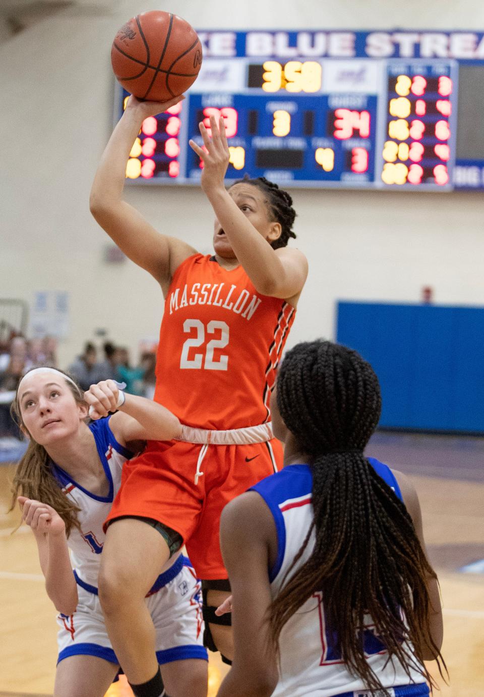 Massillon's Kaliyah Hewitt goes to the hoop with defense from Lake's Hayden Croyle, left, and Serenitee Horning in the second half at Lake Thursday, Dec. 22, 2022.