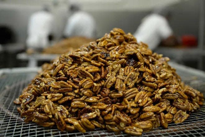 FILE - A pile of pecans sit on the line of Savannah's Candy Kitchen. Yelp ranks it as one of the best spots in the area to enjoy pralines.