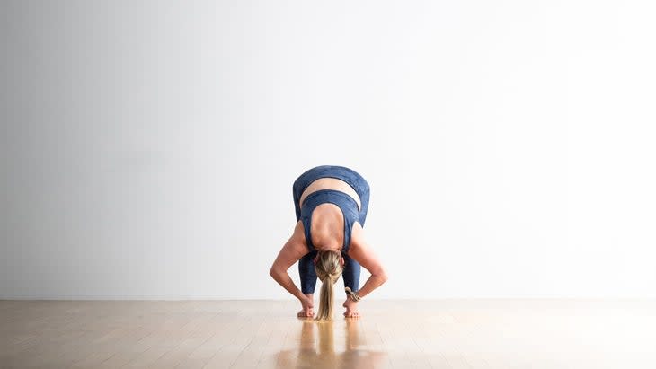 A person demonstrates Hand to Big Toe Pose in yoga