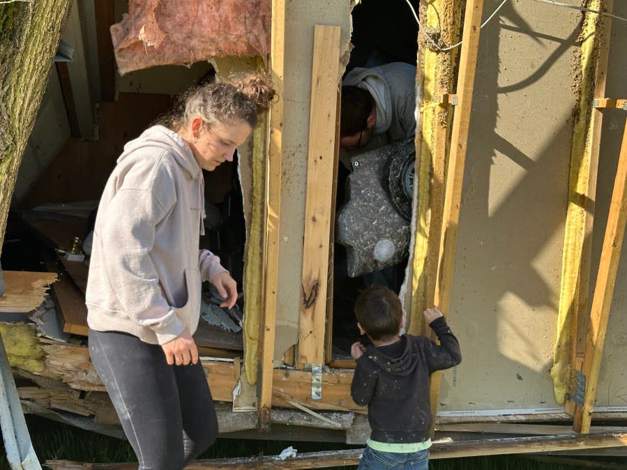 Shania Hinspeter salvages belongings after a likely tornado in the Sherwood area. (May 8, 2024)