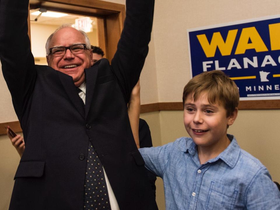 Rep. Tim Walz (D-MN) and his son Gus Walz celebrate while entering his election night party on August 14, 2018 in St Paul, Minnesota.