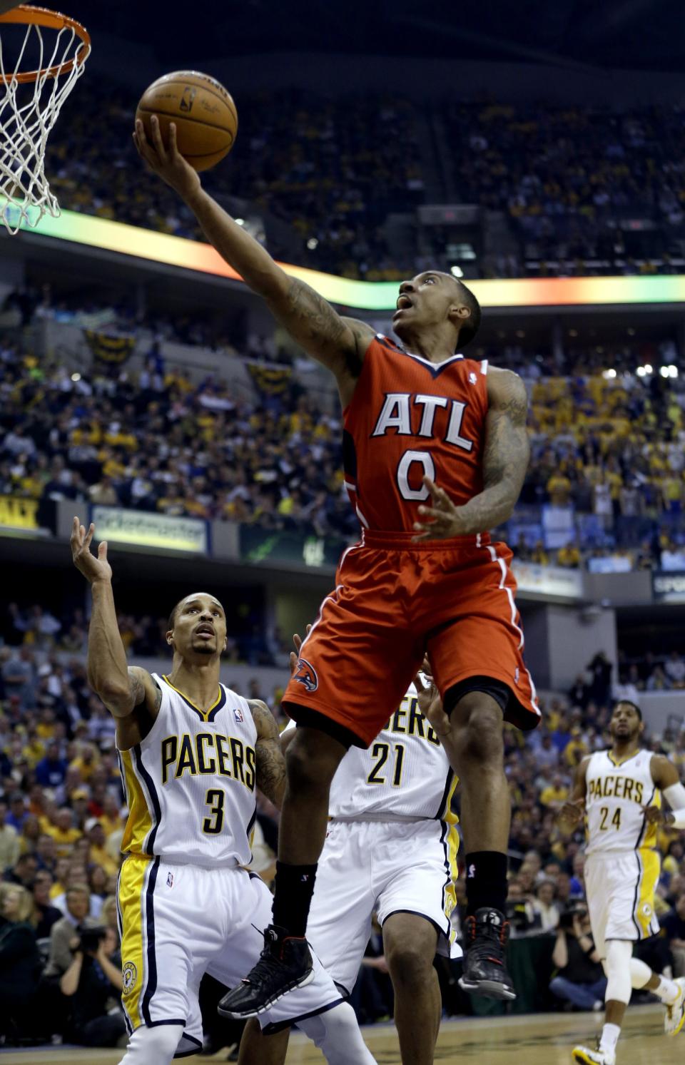 Atlanta Hawks' Jeff Teague (0) goes up for a shot as Indiana Pacers' George Hill (3) defends during the first half in Game 5 of an opening-round NBA basketball playoff series Monday, April 28, 2014, in Indianapolis. (AP Photo/Darron Cummings)