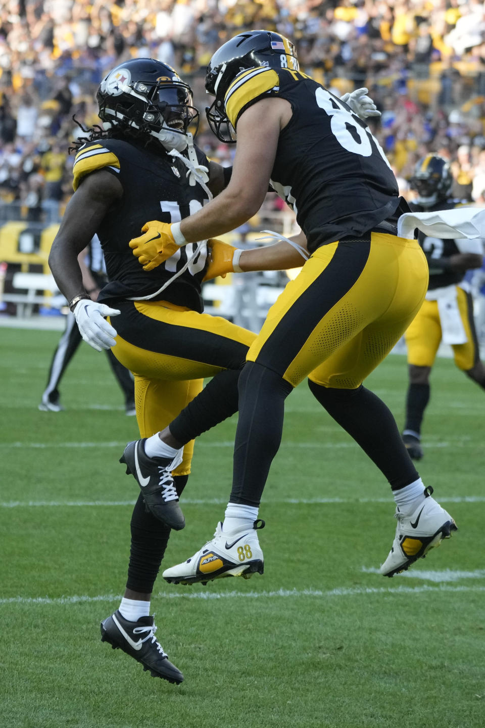 Pittsburgh Steelers wide receiver Diontae Johnson, left, celebrates with Pittsburgh Steelers tight end Pat Freiermuth, right, after Freiermuth scores a touchdown in the first half of an NFL preseason football game against the Buffalo Bills, in Pittsburgh, Saturday, Aug. 19, 2023. (AP Photo/Gene Puskar)