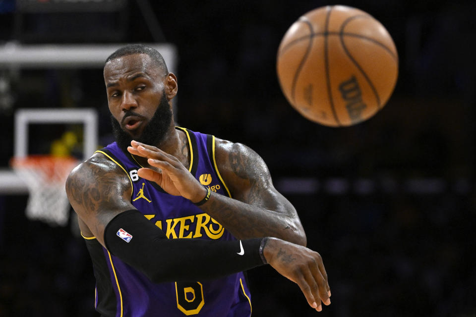 Los Angeles Lakers forward LeBron James passes the ball during the second half of an NBA basketball game against the Phoenix Suns Friday, April 7, 2023, in Los Angeles. (AP Photo/Mark J. Terrill)