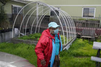 Margaret Gordon, a co-founder of the West Oakland Environmental Indicators Project, walks to her office while interviewed in Oakland, Calif., Thursday, Feb. 18, 2021. Disadvantaged communities in America are disproportionately affected by pollution from industry or waste disposal, but their complaints have few outlets and often reach a dead end. (AP Photo/Jeff Chiu)