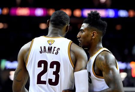 Cleveland Cavaliers guard Iman Shumpert (4) talks to forward LeBron James (23) during the fourth quarter against the Golden State Warriors in game six of the NBA Finals at Quicken Loans Arena. Mandatory Credit: Bob Donnan-USA TODAY Sports