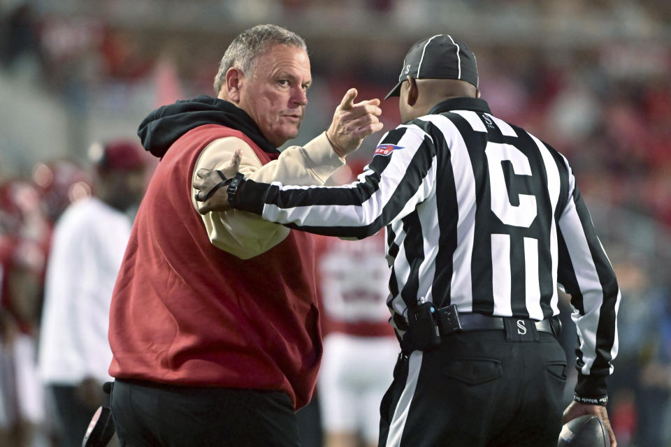 Arkansas coach Sam Pittman talks with an official during the first half of the team's NCAA college football game against Florida International on Saturday, Nov. 18, 2023, in Fayetteville, Ark. (AP Photo/Michael Woods)