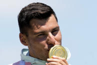 Sandor Totka, of Hungary, kisses his gold medal in the men's kayak single 200m final at the 2020 Summer Olympics, Thursday, Aug. 5, 2021, in Tokyo, Japan. (AP Photo/Kirsty Wigglesworth)