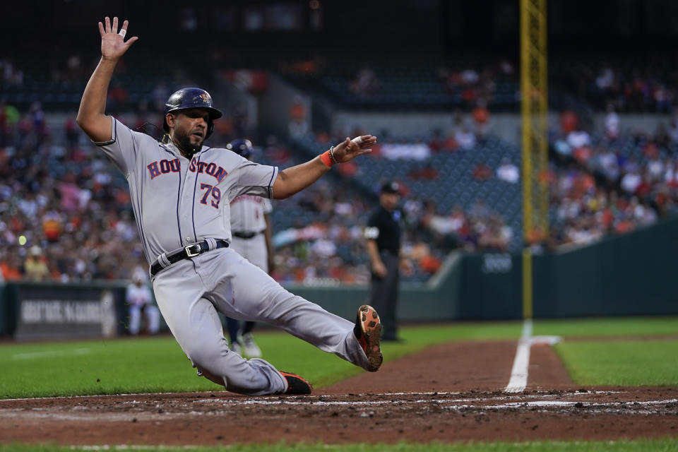 Houston Astros' Jose Abreu scores on a single by Jose Altuve in the second inning of a baseball game against the Baltimore Orioles, Wednesday, Aug. 9, 2023, in Baltimore. (AP Photo/Julio Cortez)