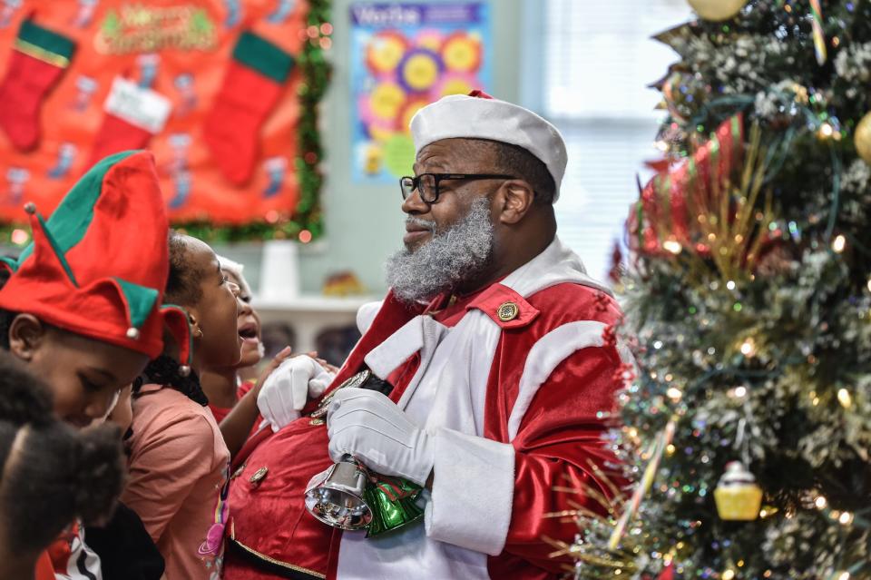 Larry “Santa” Williamson visits with young children at Kids are Kids Learning Center in Brandon on Tuesday.