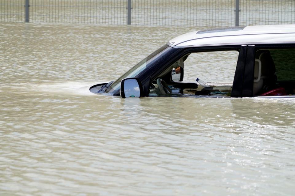 Debris floats through an SUV abandoned in floodwater in Dubai, United Arab Emirates, Wednesday, April 17, 2024 (AP)