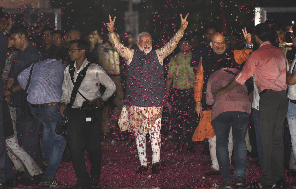 Indian Prime Minister Narendra Modi and Bharatiya Janata Party (BJP) President Amit Shah greet supporters on arrival at the party headquarters in New Delhi, India, Thursday, May 23, 2019. Modi's Hindu nationalist party claimed it won reelection with a commanding lead in Thursday's vote count, while the head of the main opposition party conceded a personal defeat that signaled the end of an era for modern India's main political dynasty. (AP Photo)