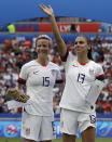 FILE - United States' Megan Rapinoe, left, and her teammate Alex Morgan, right, react after winning the Women's World Cup final soccer match between the United States and The Netherlands at the Stade de Lyon in Decines, outside Lyon, France, Sunday, July 7, 2019. U.S. women soccer players reached a landmark agreement with the sport’s American governing body to end a six-year legal battle over equal pay, a deal in which they are promised $24 million plus bonuses that match those of the men. The U.S. Soccer Federation and the women announced a deal Tuesday, Feb. 22, 2022, that will have players split $22 million, about one-third of what they had sought in damages. (AP Photo/Alessandra Tarantino, File)