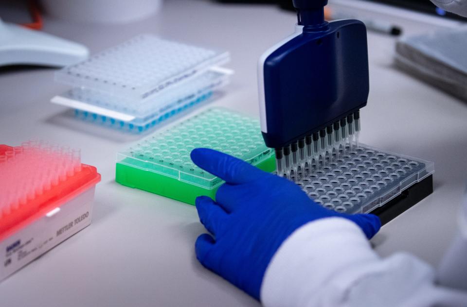 Amber Whitaker performs genome sequencing on positive COVID-19 tests in a research lab, Oct. 4, 2021, at TGen North in Flagstaff, Arizona.