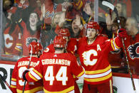 Calgary Flames forward Matthew Tkachuk, right, celebrates his goal with teammates during second period NHL playoff hockey action against the Dallas Stars in Calgary, Alberta, Sunday, May 15, 2022. (Jeff McIntosh/The Canadian Press via AP)