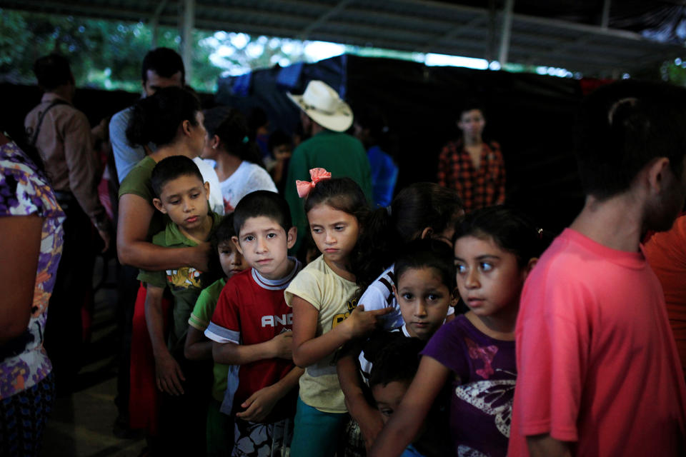 Children from El Castano village line up for dinner at a shelter in Caluco, El Salvador, on Sept. 26, 2016, after leaving home because of death threats from Barrio 18 gang members. (Photo: Jose Cabezas/Reuters)