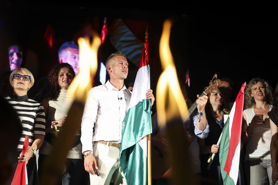 Top candidate for the European elections of the Respect and Freedom (TISZA) Party Peter Magyar sings with his supporters during the party's election night party after the European Parliament and local elections in Budapest, Hungary, early Monday, June 10, 2024. (Robert Hegedus/MTI via AP)