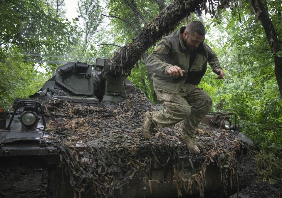 FILE - A Ukrainian soldier jumping off the German self-propelled Panzerhaubitze 2000 artillery at his position at the frontline near Bakhmut, Donetsk region, Ukraine, on May 27, 2023. When Russia invaded Ukraine in February 2022, Ukraine’s military was largely reliant on Soviet-era weaponry. While that arsenal helped Ukraine fend off an assault on the capital of Kyiv and prevent a total rout in the early weeks of the war, billions of dollars in military assistance has since poured into the country, including more modern Western-made weapons. (AP Photo/Efrem Lukatsky, File)