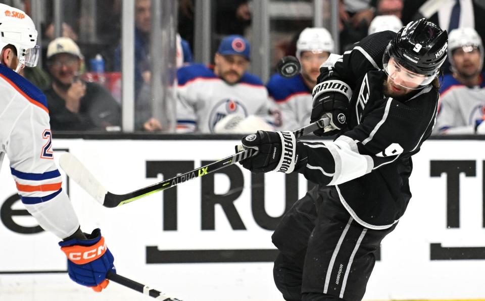 An Edmonton Oilers player blocks a shot by Kings forward Adrian Kempe.