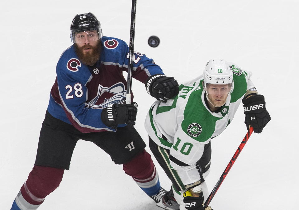 Dallas Stars' Corey Perry (10) and Colorado Avalanche's Ian Cole (28) look for the loose puck during the third period of an NHL Western Conference Stanley Cup playoff game, Monday, Aug. 31, 2020, in Edmonton, Alberta. (Jason Franson/The Canadian Press via AP)