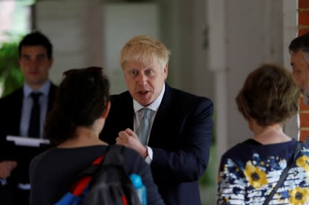Boris Johnson, a leadership candidate for Britain's Conservative Party, talks with visitors and staff during a walkabout at Wisley Garden Centre in Surrey